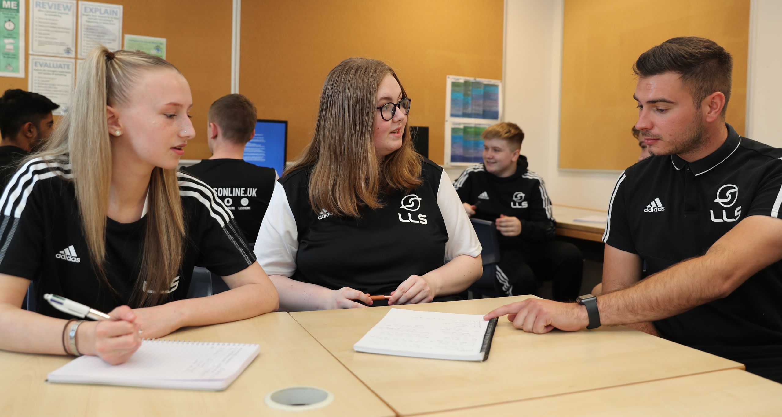 students and tutor in classroom